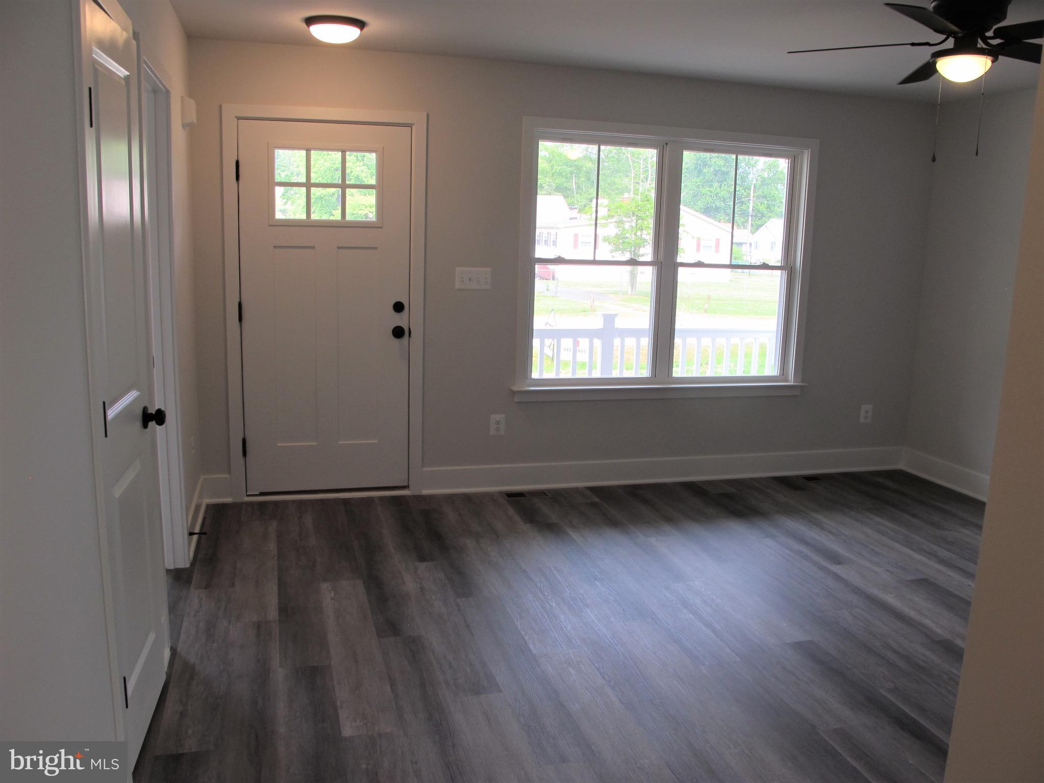 23 A 9th Street Colonial Beach, VA 22443 - Photo 11 of 56 a view of an empty room with wooden floor and a window
