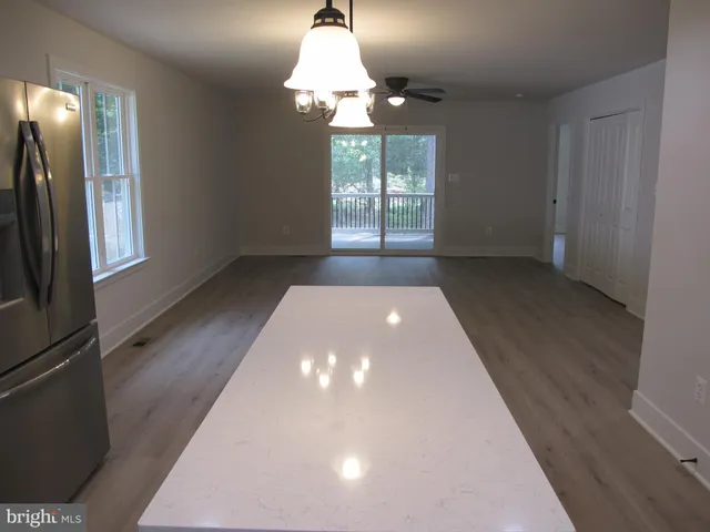 a kitchen with stainless steel appliances a refrigerator sink and wooden cabinets