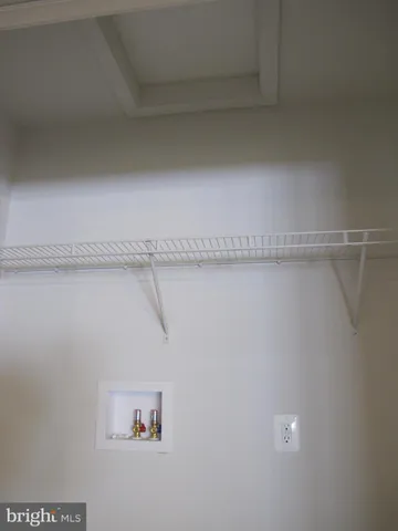 a utility room with refrigerator and washer