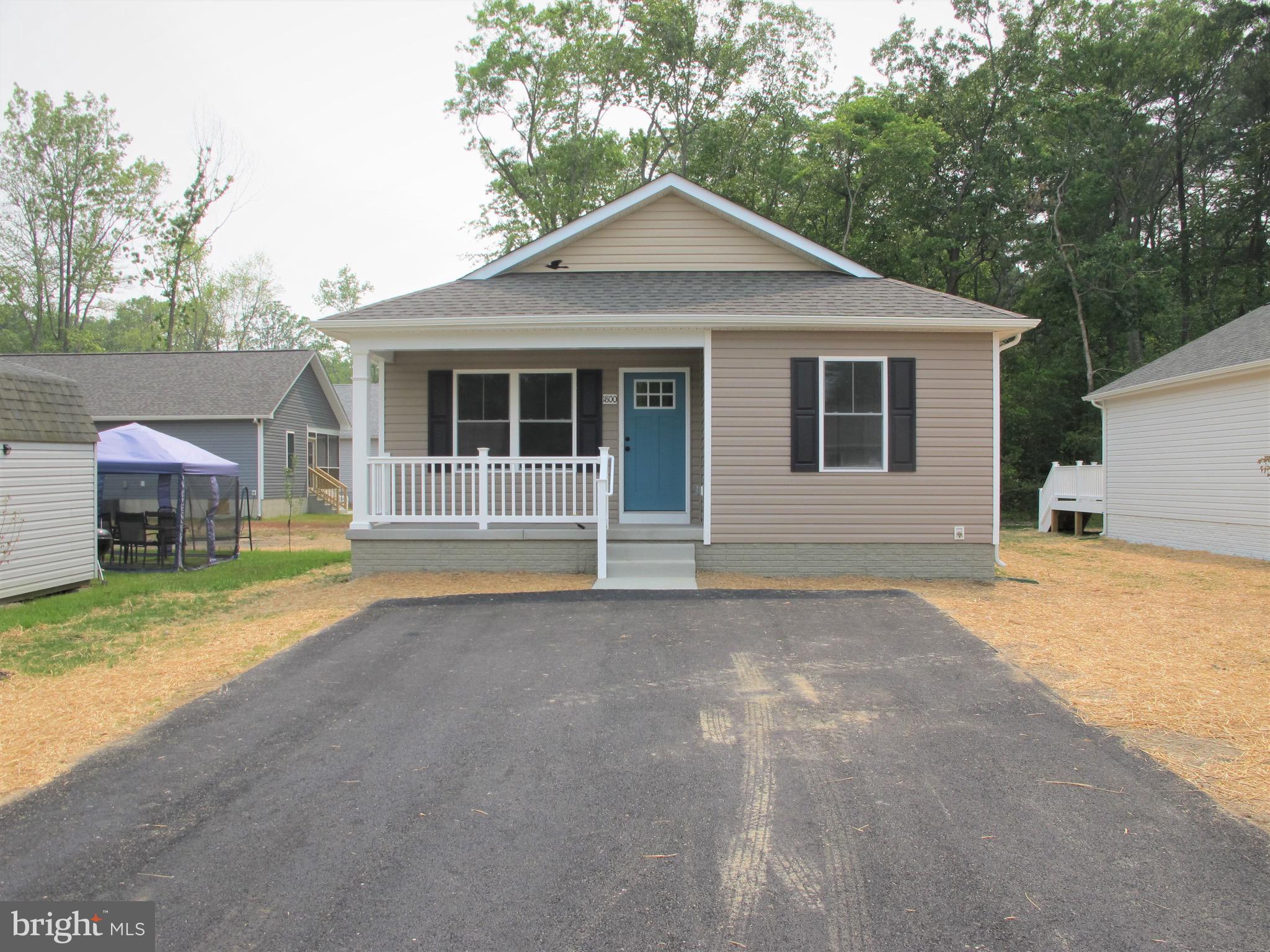 23 A 9th Street Colonial Beach, VA 22443 - Photo 3 of 56 a front view of a house with a yard and garage