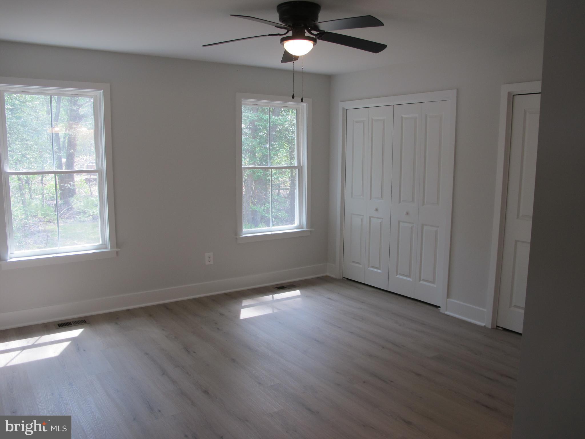 23 A 9th Street Colonial Beach, VA 22443 - Photo 42 of 56 a view of an empty room with wooden floor and a window