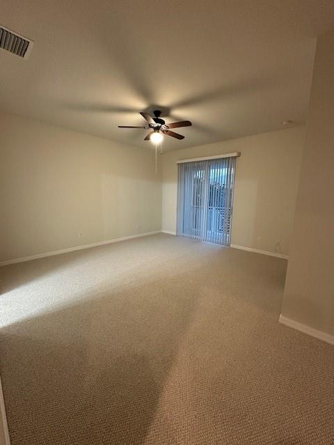 1143 Community Drive Jupiter, FL 33458 - Photo 11 of 15 an empty room with windows and fan