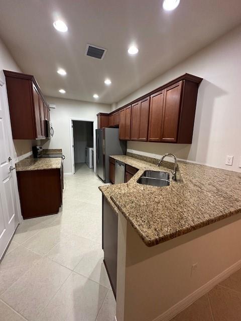 1143 Community Drive Jupiter, FL 33458 - Photo 3 of 15 a kitchen with kitchen island granite countertop a sink refrigerator and microwave