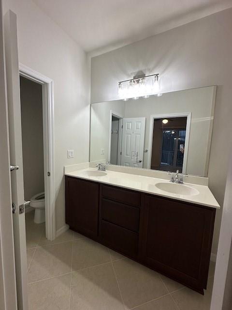 1143 Community Drive Jupiter, FL 33458 - Photo 9 of 15 a bathroom with a double vanity sink and mirror