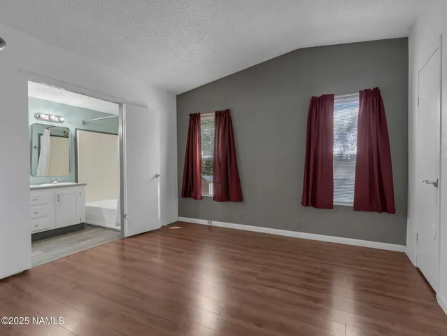 a bathroom with a double vanity sink mirror and shower