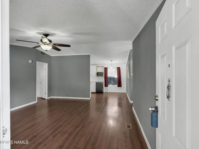 a view of livingroom with hardwood floor and a ceiling fan