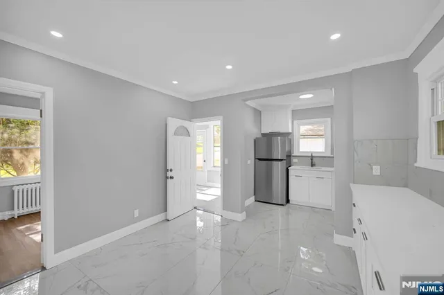 a view of kitchen with refrigerator and window