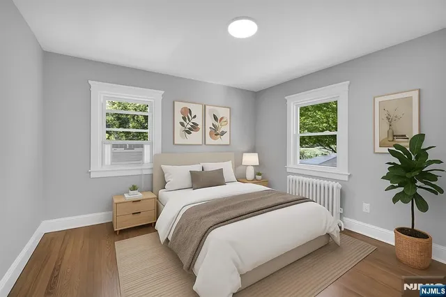 a bedroom with a bed and a potted plant