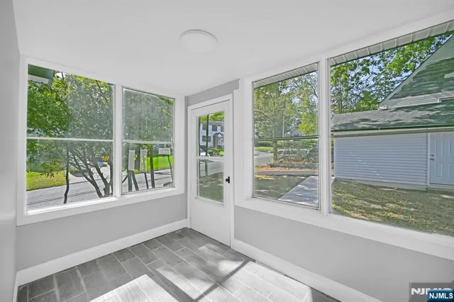 front view of a house with a tree