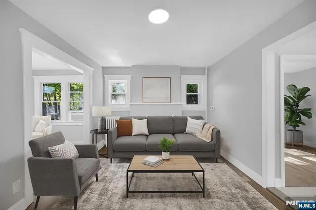 a living room with furniture and a potted plant