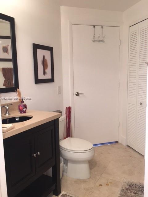801 Brickell Key Boulevard, Unit 1004 Miami, FL 33131 - Photo 14 of 24 a bathroom with a toilet a sink and mirror
