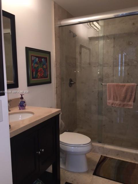 801 Brickell Key Boulevard, Unit 1004 Miami, FL 33131 - Photo 17 of 24 a bathroom with a sink a toilet and shower