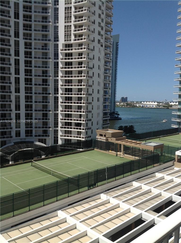 801 Brickell Key Boulevard, Unit 1004 Miami, FL 33131 - Photo 21 of 24 a view of a swimming pool with a yard