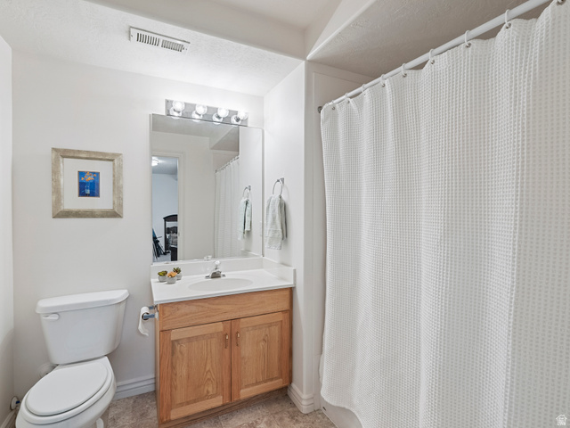 11881 Cottage View Lane Draper, UT 84020 - Photo 19 of 29 Bathroom featuring a single vanity with wood-finish cabinetry, a white countertop, and a white basin sink