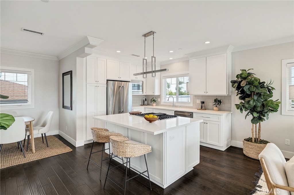 17512 Van Ness Avenue Torrance, CA 90504 - Photo 2 of 41 a kitchen with stainless steel appliances kitchen island a table chairs refrigerator and sink