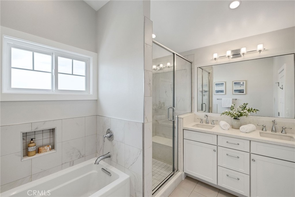 17512 Van Ness Avenue Torrance, CA 90504 - Photo 31 of 41 a bathroom with a tub a sink double vanity and mirror
