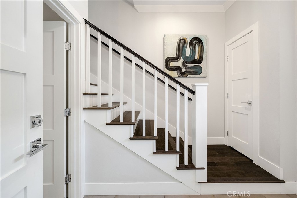 17512 Van Ness Avenue Torrance, CA 90504 - Photo 5 of 41 a view of staircase with lots of frames on wall and wooden floor