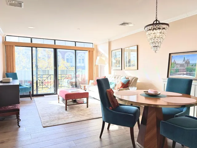a dining room with furniture a rug and wooden floor