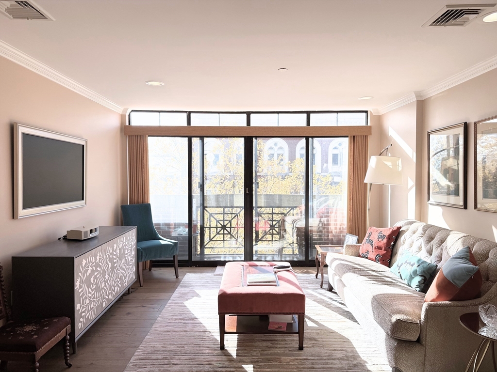 540 East Broadway, Unit 5A Boston, MA 02127 - Photo 2 of 17 a living room with furniture and a flat screen tv