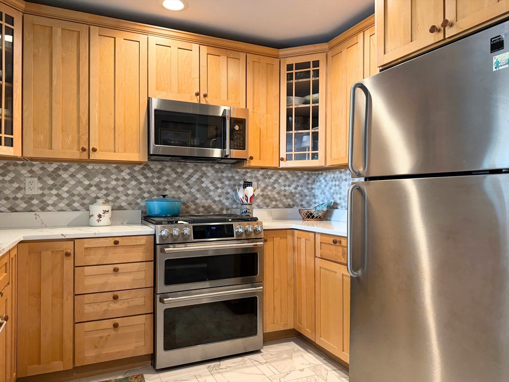 540 East Broadway, Unit 5A Boston, MA 02127 - Photo 5 of 17 a kitchen with appliances a microwave and cabinets
