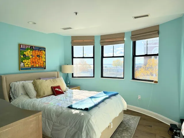 a bedroom with a bed and glass window