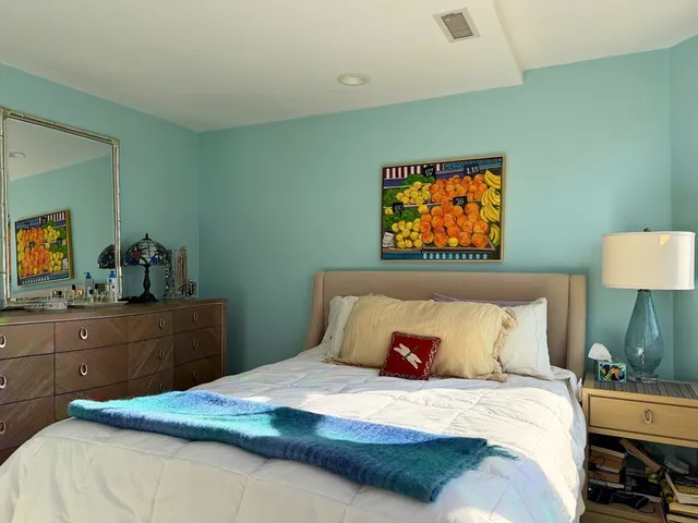 a bedroom with a bed and a dresser