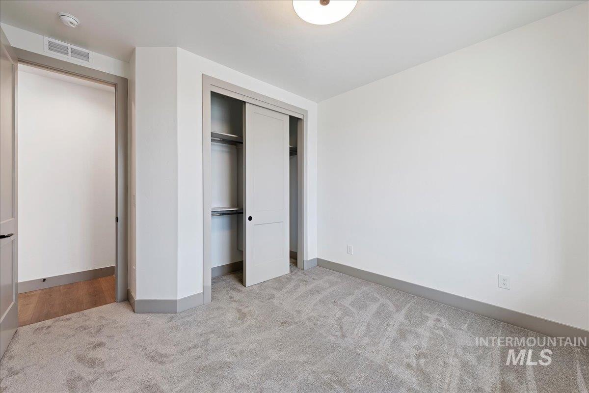 967 West Malbar Street Meridian, ID 83646 - Photo 21 of 33 Unfurnished bedroom featuring light carpet and a closet