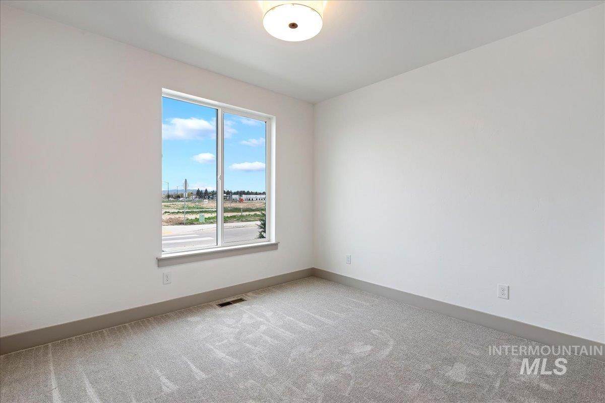 967 West Malbar Street Meridian, ID 83646 - Photo 22 of 33 Unfurnished room with baseboards and light carpet
