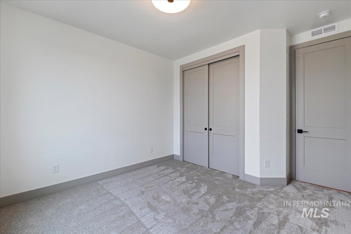 967 West Malbar Street Meridian, ID 83646 - Photo 23 of 33 Unfurnished bedroom featuring light colored carpet and a closet
