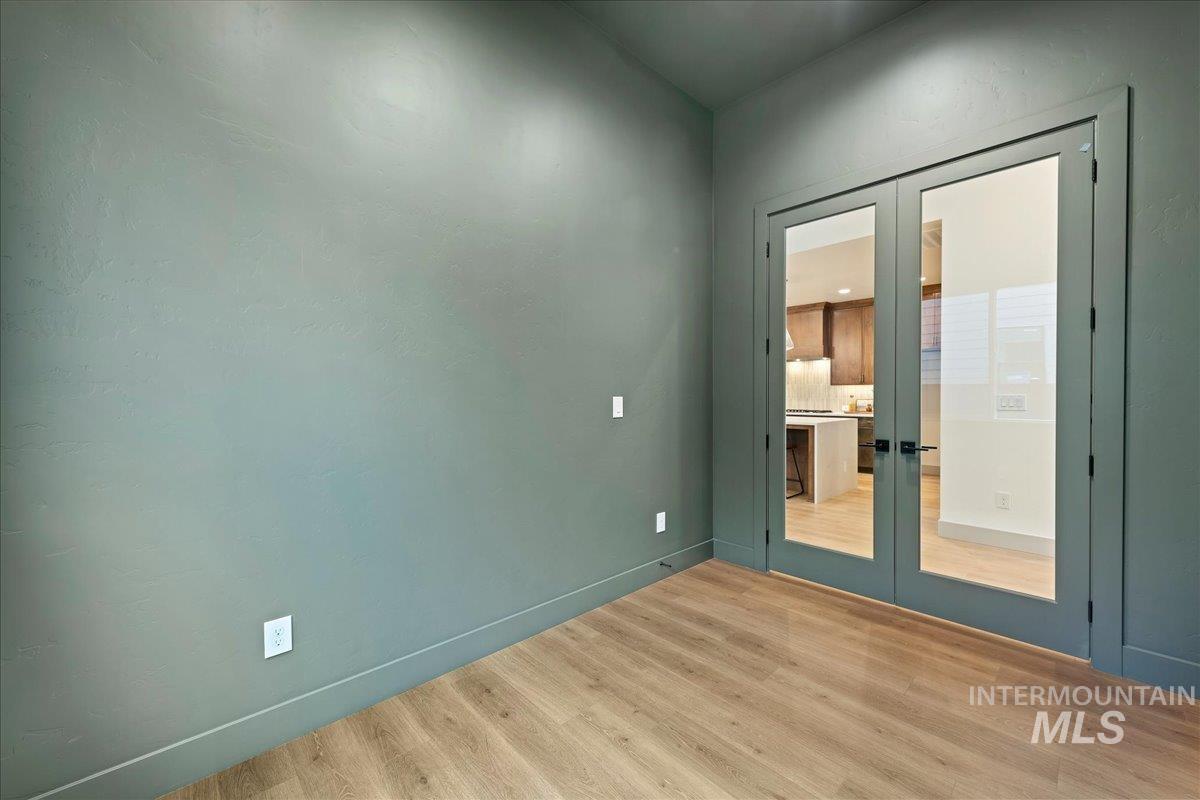 967 West Malbar Street Meridian, ID 83646 - Photo 25 of 33 Empty room featuring french doors and light wood-style floors