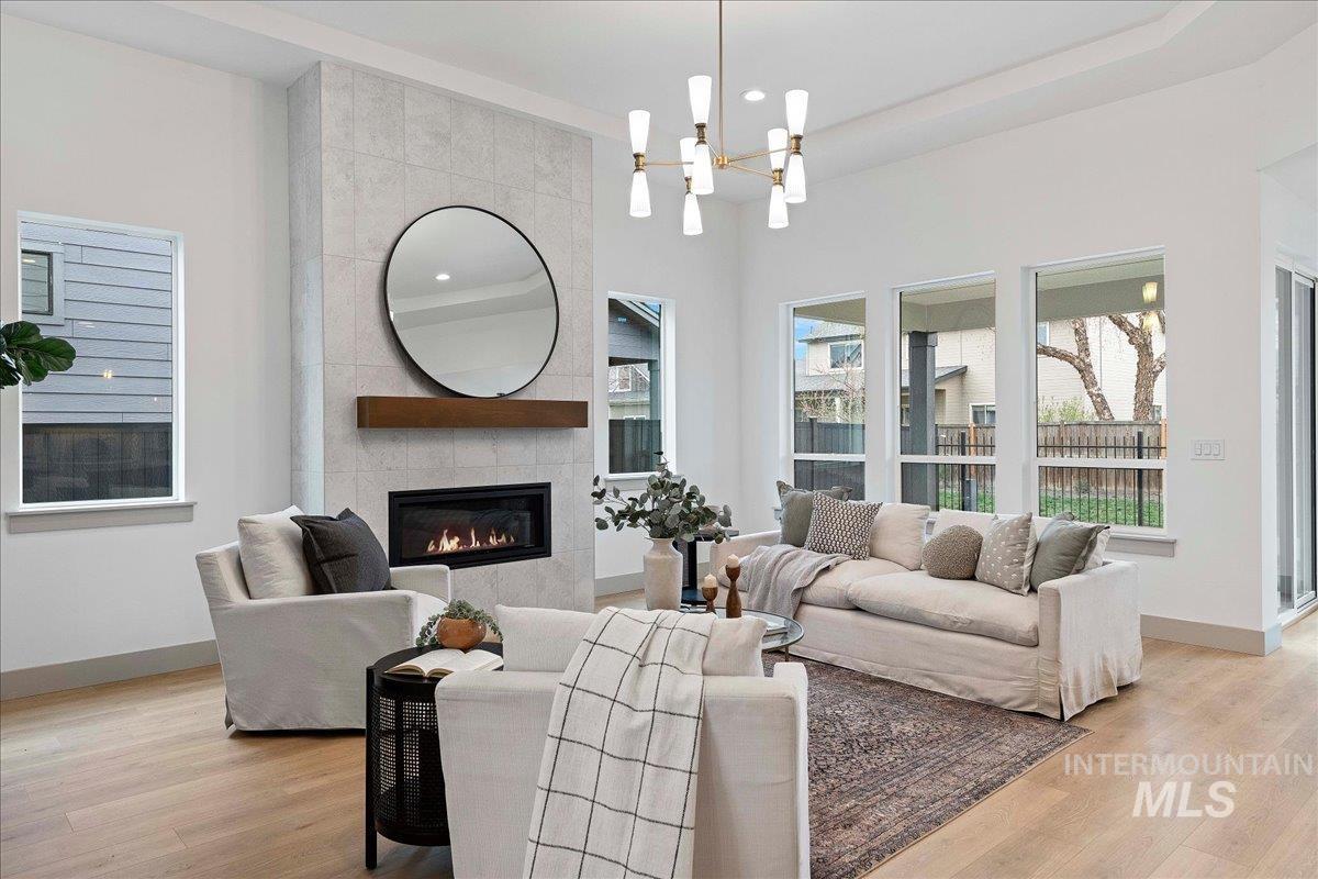 967 West Malbar Street Meridian, ID 83646 - Photo 3 of 33 Living room with a fireplace, light wood-style flooring, and hanging lights