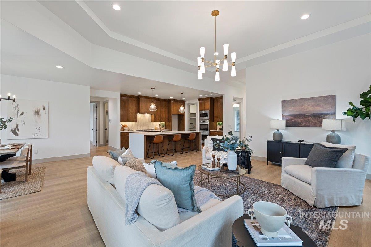 967 West Malbar Street Meridian, ID 83646 - Photo 7 of 33 Living room with suspended lighting, light wood-type flooring, and a raised ceiling