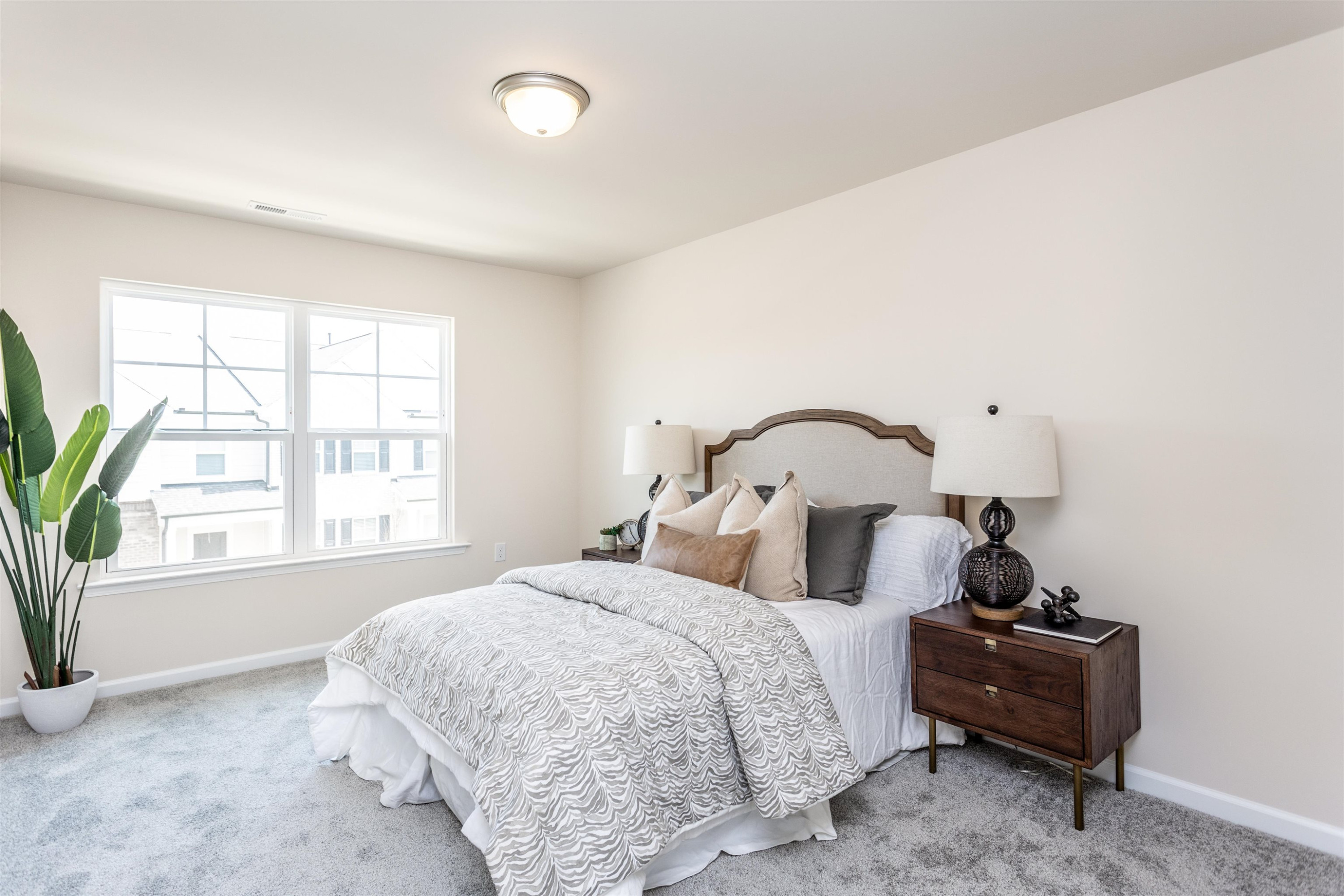 5602 Preveza Place Raleigh, NC 27603 - Photo 16 of 21 a bedroom with a bed and a window