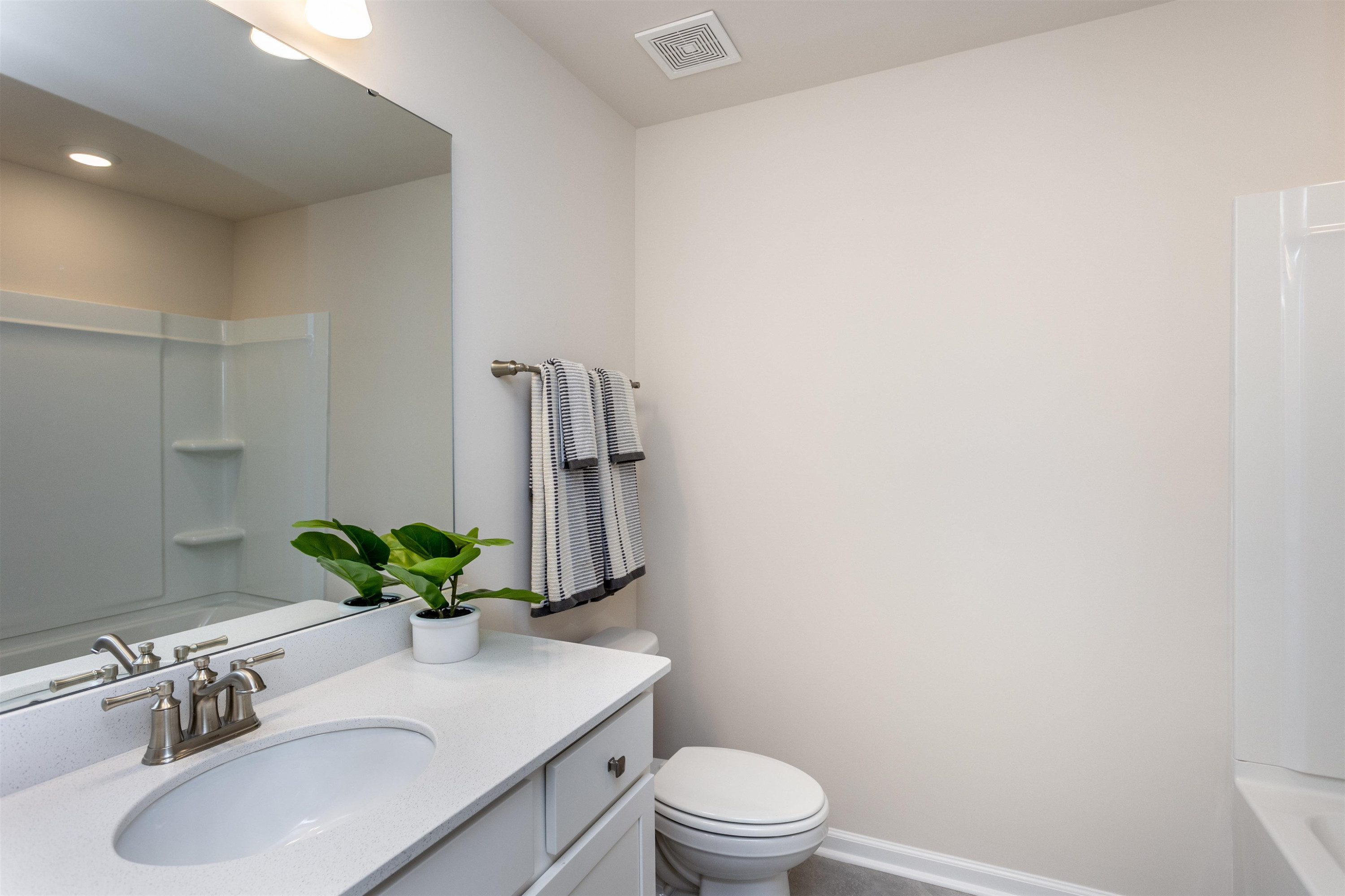5602 Preveza Place Raleigh, NC 27603 - Photo 18 of 21 a bathroom with a sink a toilet and vanity