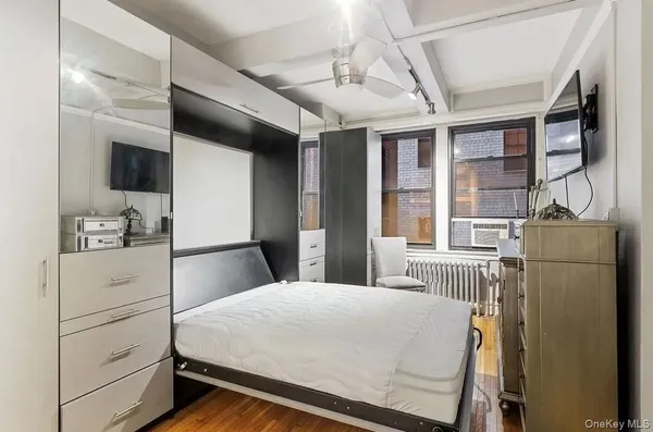 a bed room with a bed and a television