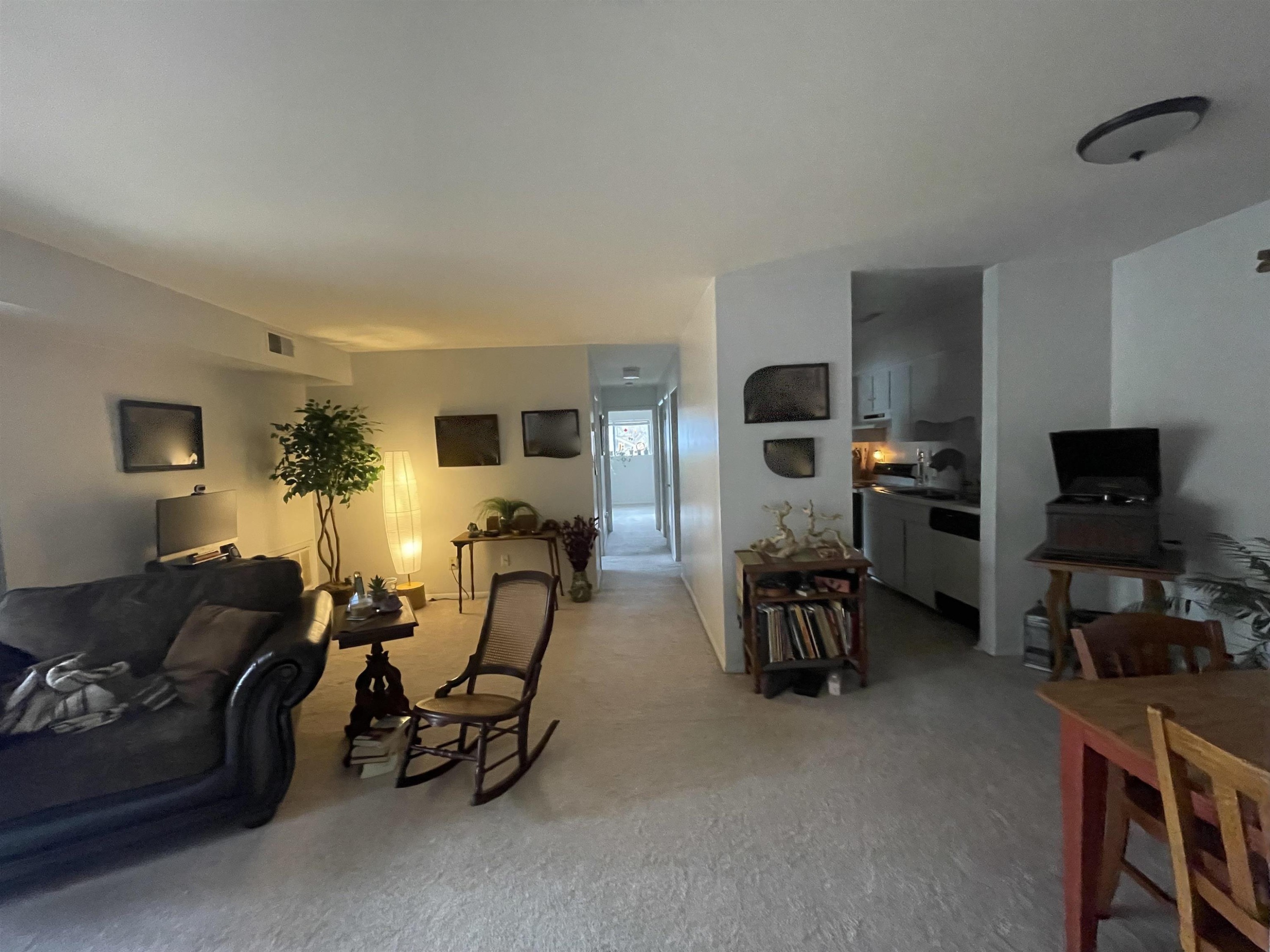 1010 Sandlin Place, Unit H Raleigh, NC 27606 - Photo 3 of 15 a living room with furniture and a flat screen tv