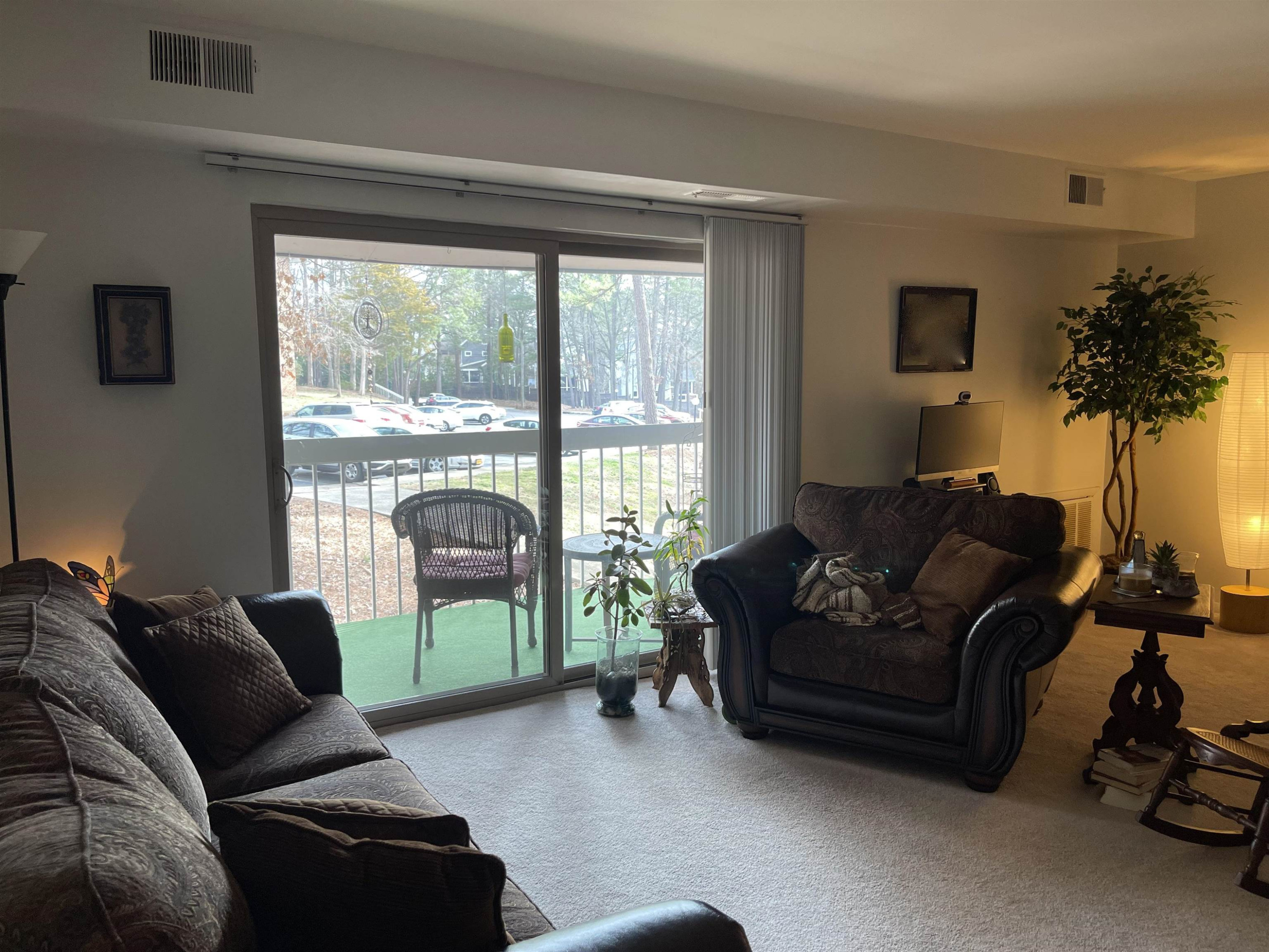 1010 Sandlin Place, Unit H Raleigh, NC 27606 - Photo 4 of 15 a living room with furniture and a floor to ceiling window