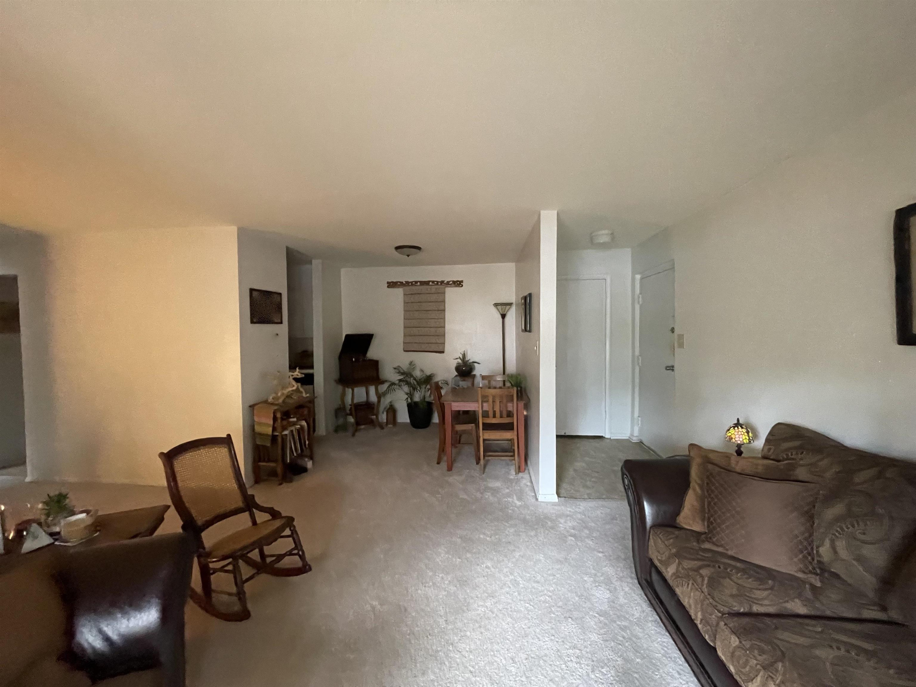 1010 Sandlin Place, Unit H Raleigh, NC 27606 - Photo 5 of 15 a living room with furniture and a chair