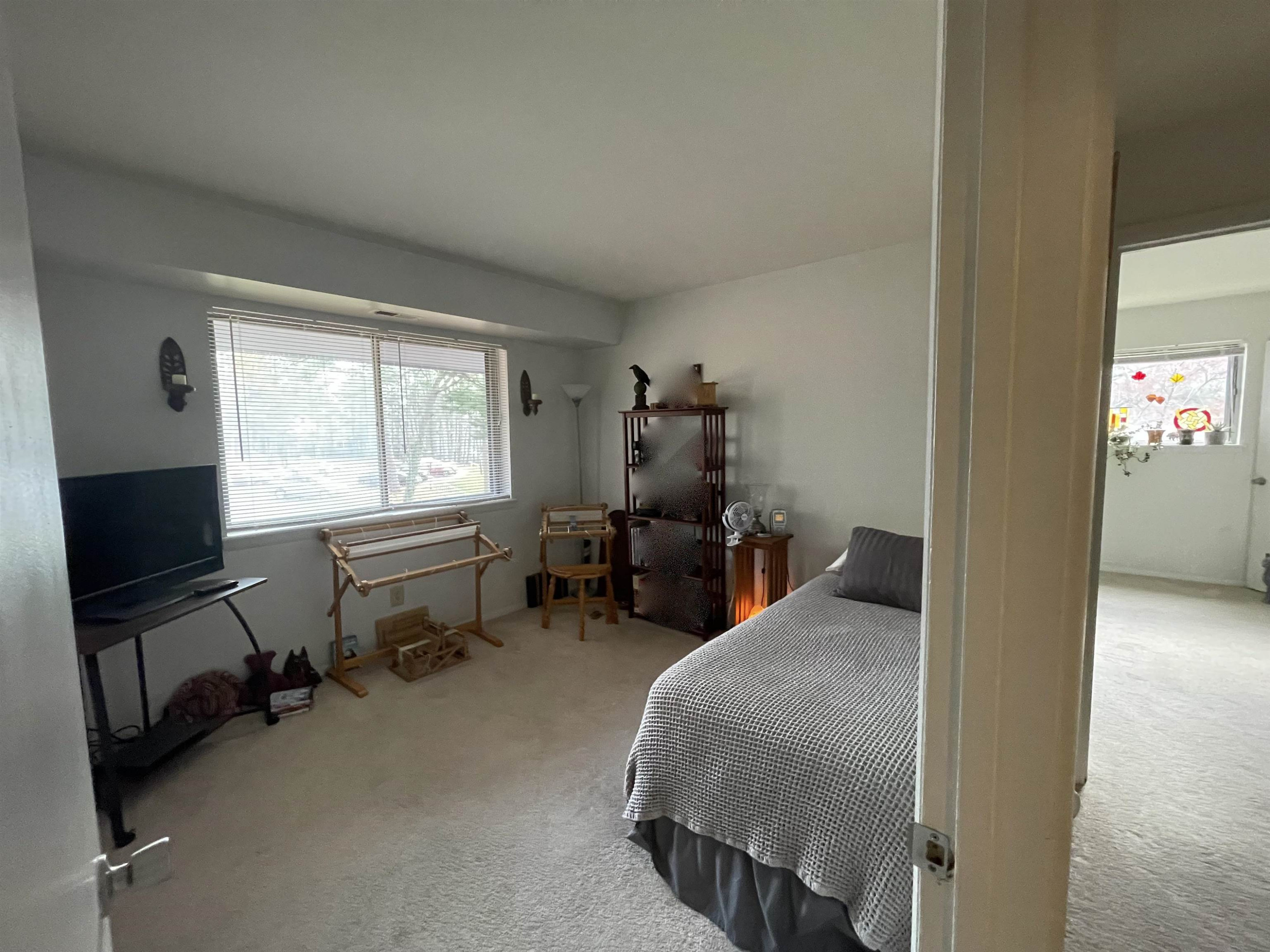 1010 Sandlin Place, Unit H Raleigh, NC 27606 - Photo 8 of 15 a bedroom with furniture and a window