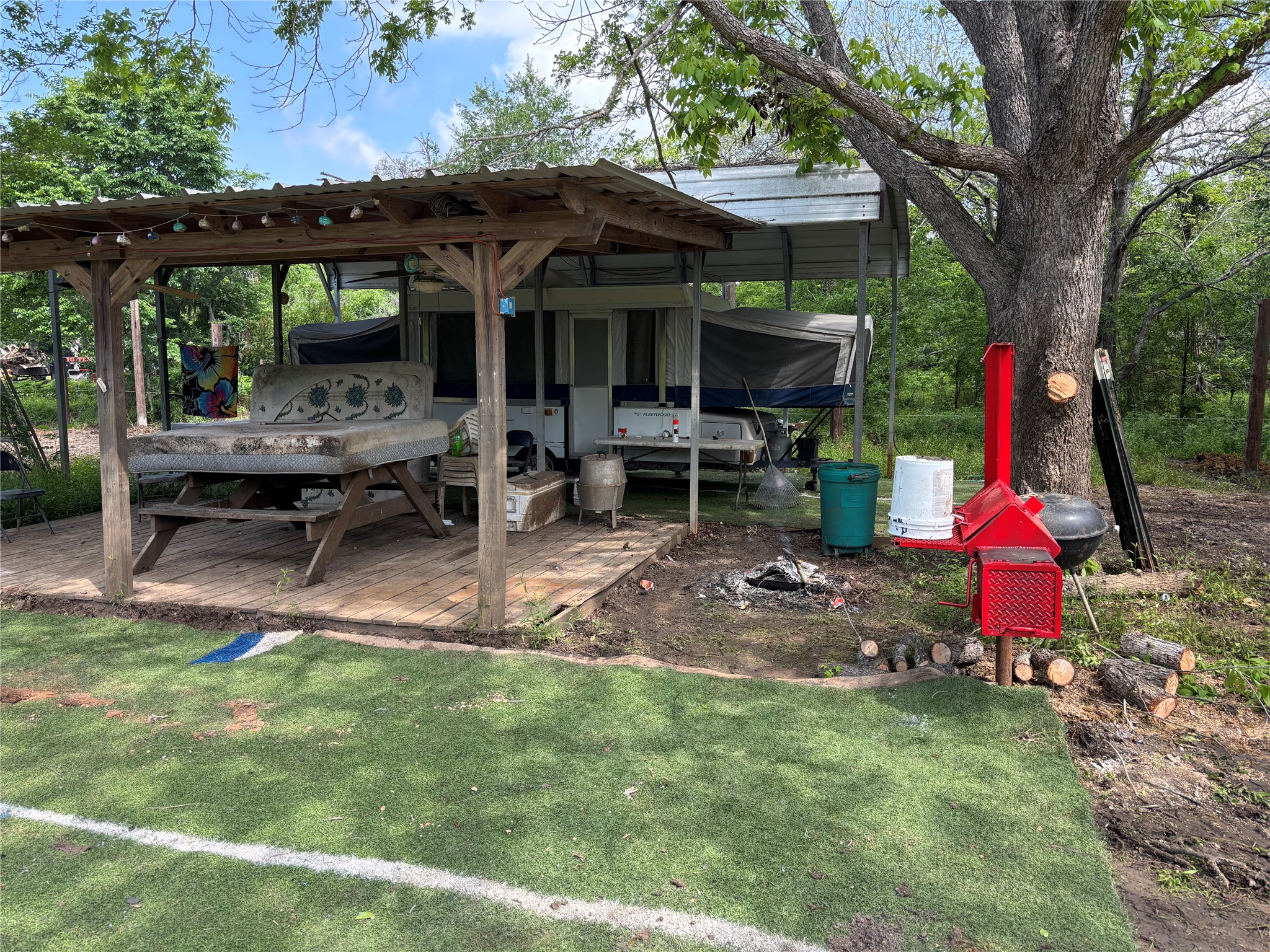 161 Powell Road Trinity, TX 75862 - Photo 4 of 4 a view of backyard with table and chairs and a large tree
