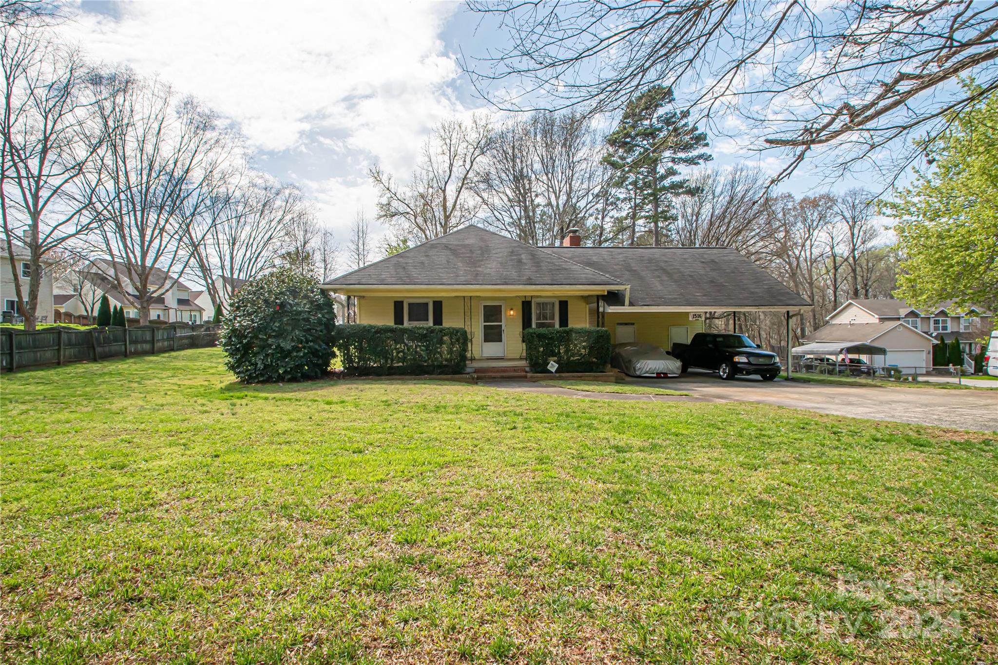 a front view of a house with a yard and trees