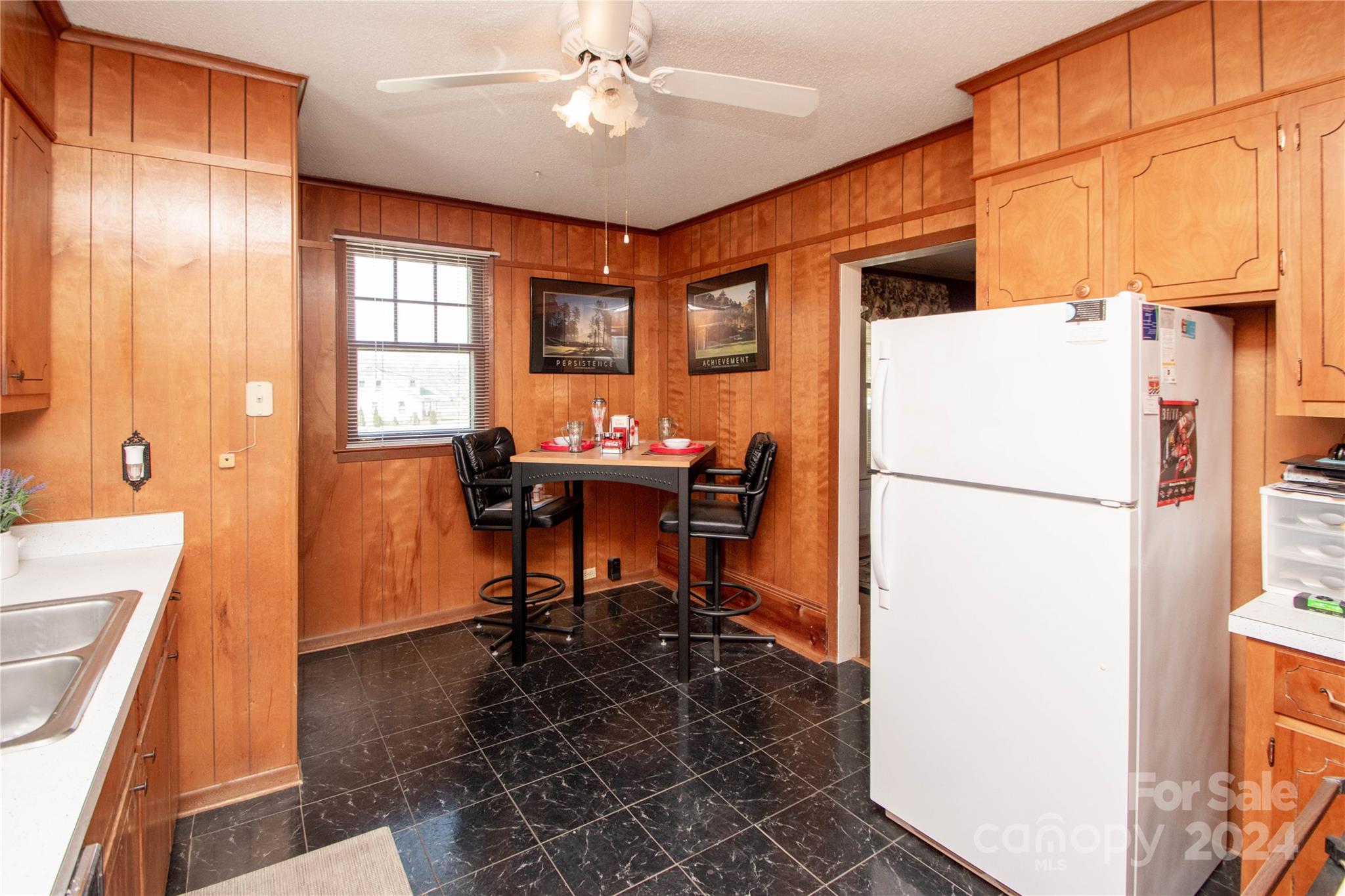 1516 Pleasant Plains Road Matthews, NC 28105 - Photo 13 of 29 a dining room with a table chairs and a refrigerator