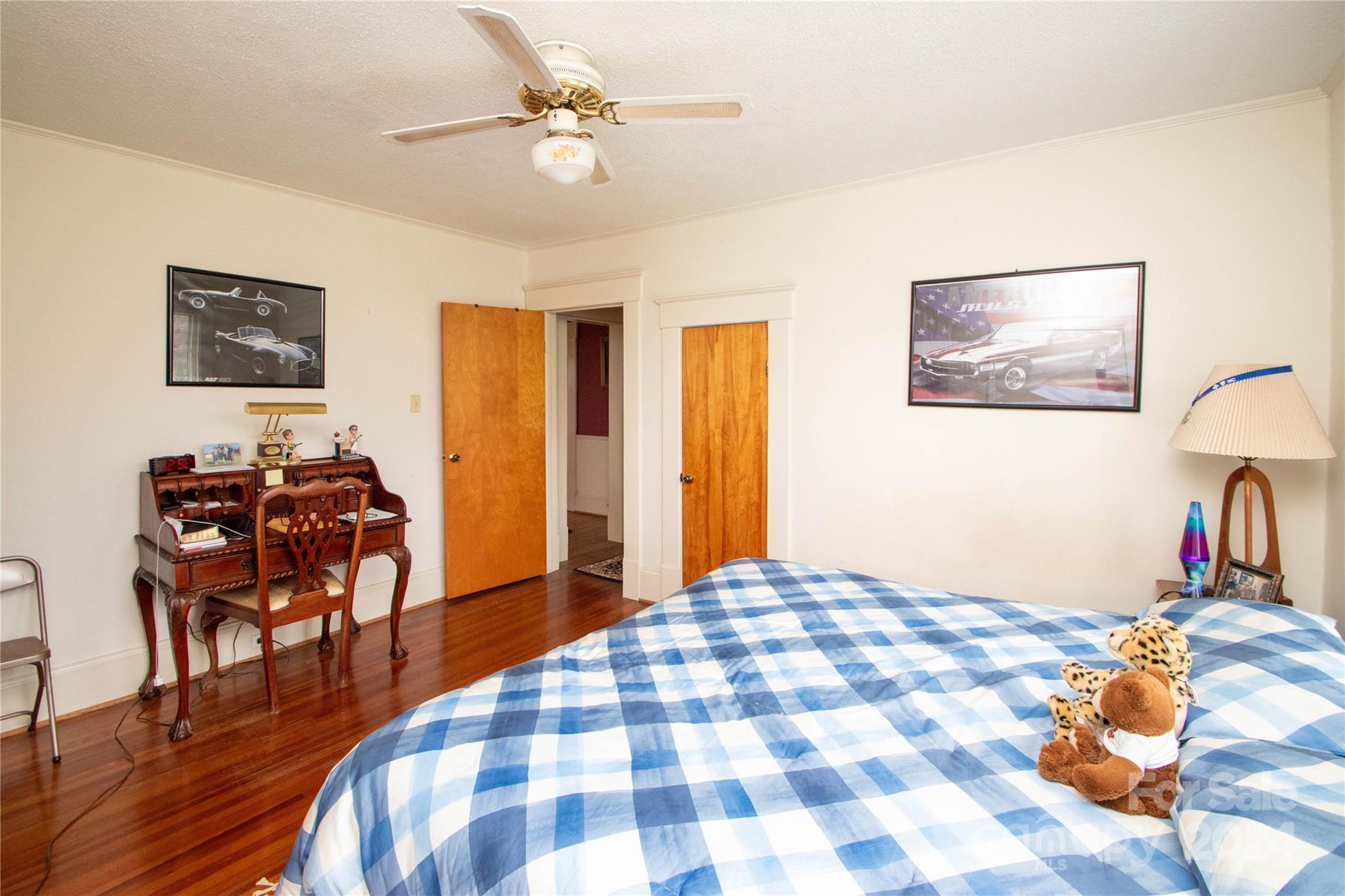 1516 Pleasant Plains Road Matthews, NC 28105 - Photo 15 of 29 a bedroom with a bed and a chandelier