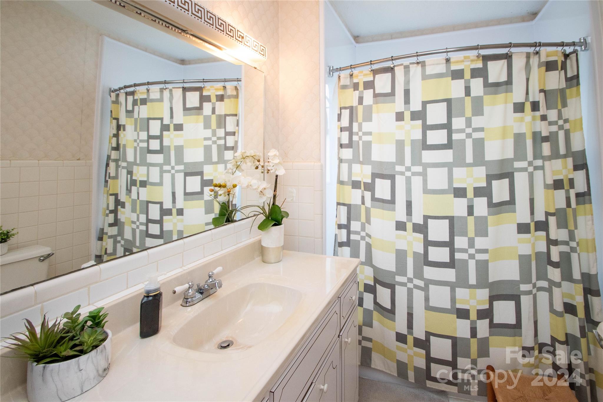 1516 Pleasant Plains Road Matthews, NC 28105 - Photo 17 of 29 a bathroom with a granite countertop sink a mirror and shower