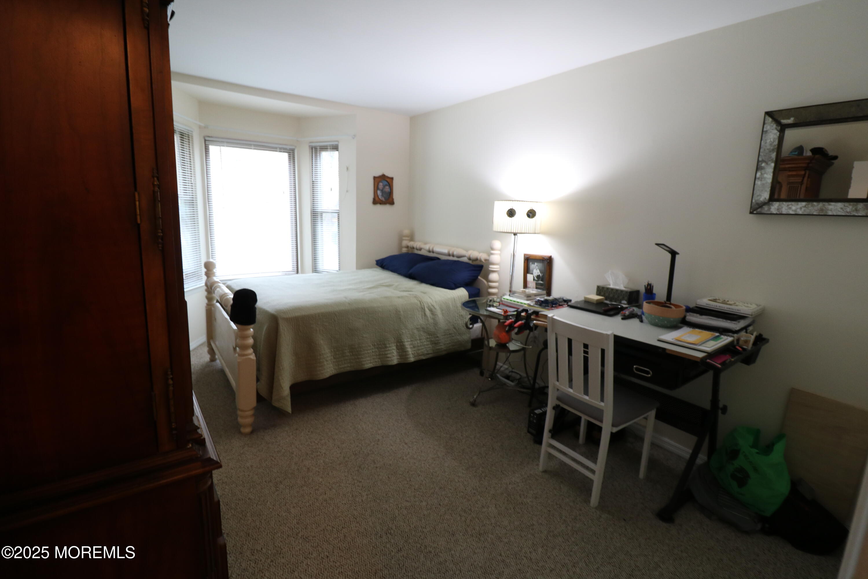 200 Portland Road, Unit E23 Highlands, NJ 07732 - Photo 16 of 33 a bedroom with a bed and a desk in it