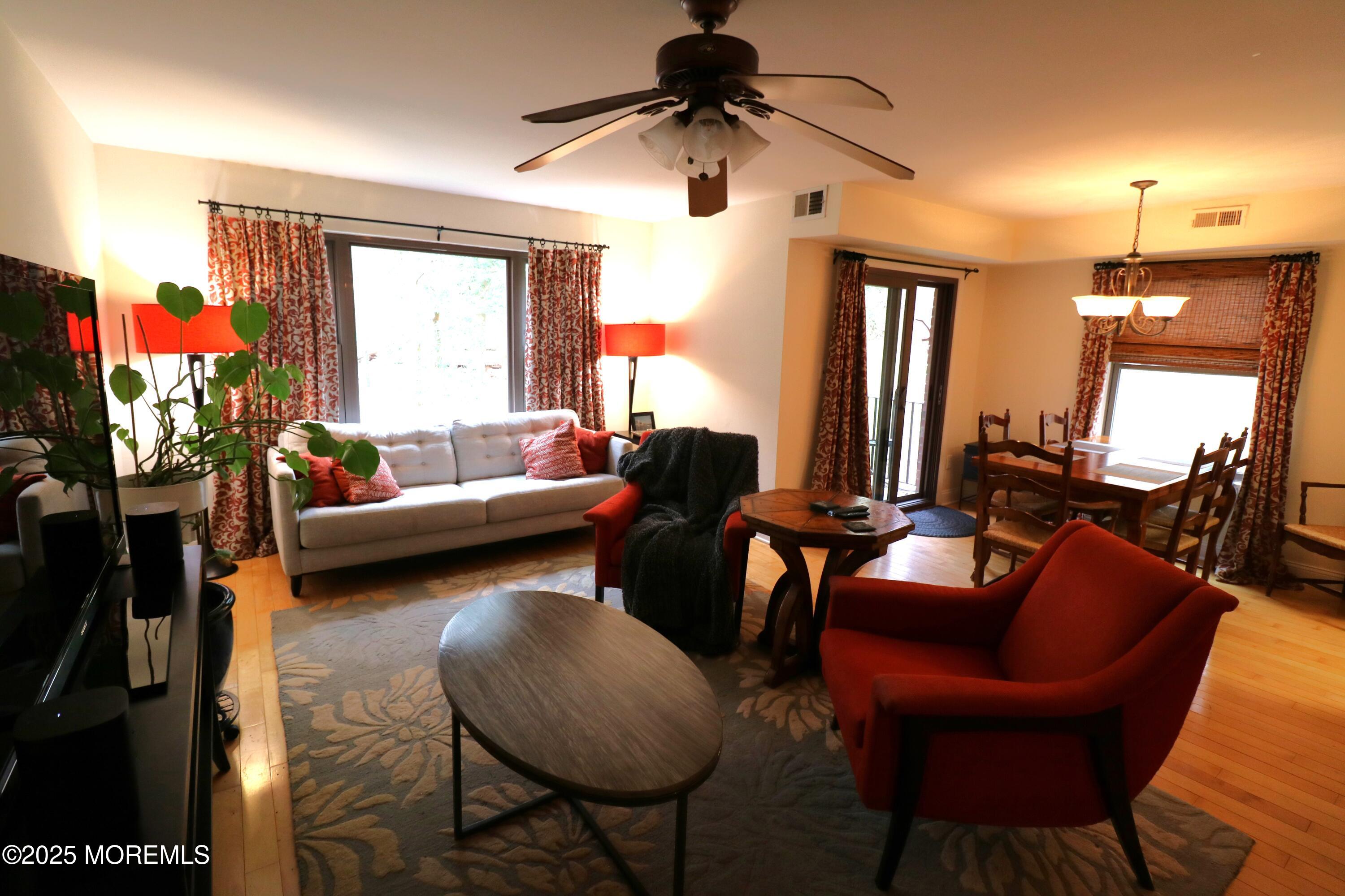 200 Portland Road, Unit E23 Highlands, NJ 07732 - Photo 7 of 33 a living room with furniture a lamp and a chandelier