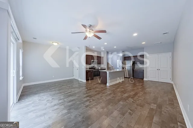 a view of kitchen with furniture and refrigerator