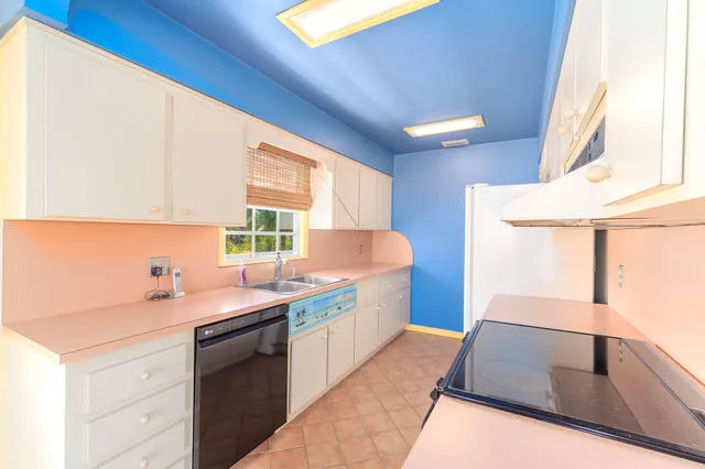 a kitchen with a stove and a white refrigerator