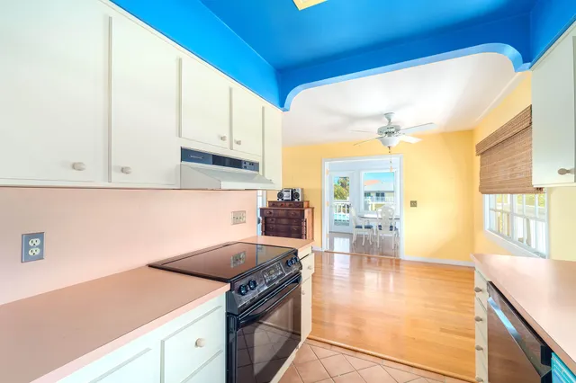 a dining room with furniture window and wooden floor