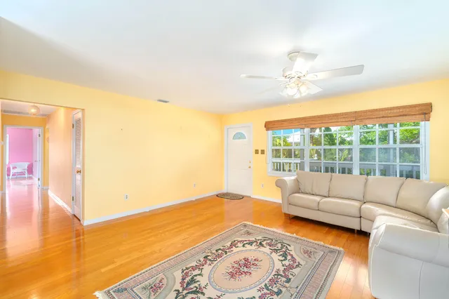 a room with a bed and a view of kitchen